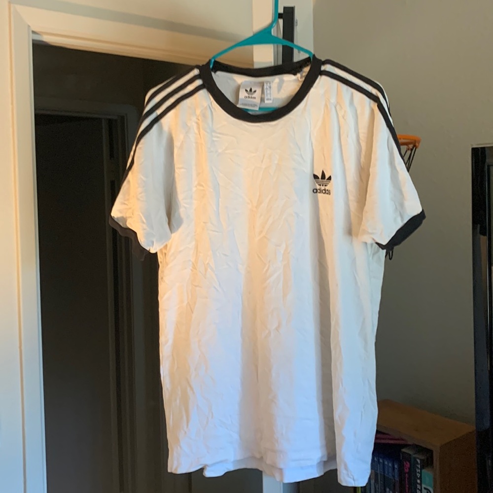 White adidas tee with stripes along the shoulders in good condition